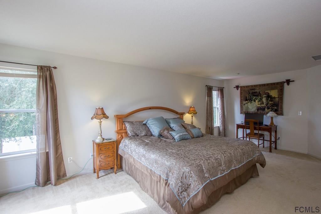 3 Riddle Place Palm Coast, FL 32164 - Photo 33 of 47 a bedroom with a large bed and a window