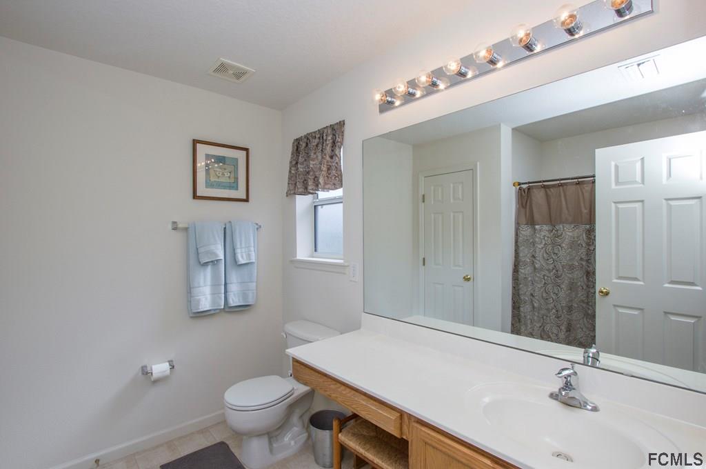 3 Riddle Place Palm Coast, FL 32164 - Photo 35 of 47 a bathroom with a sink a toilet and shower