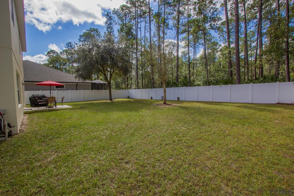 3 Riddle Place Palm Coast, FL 32164 - Photo 38 of 47 a view of a green field with trees in the background
