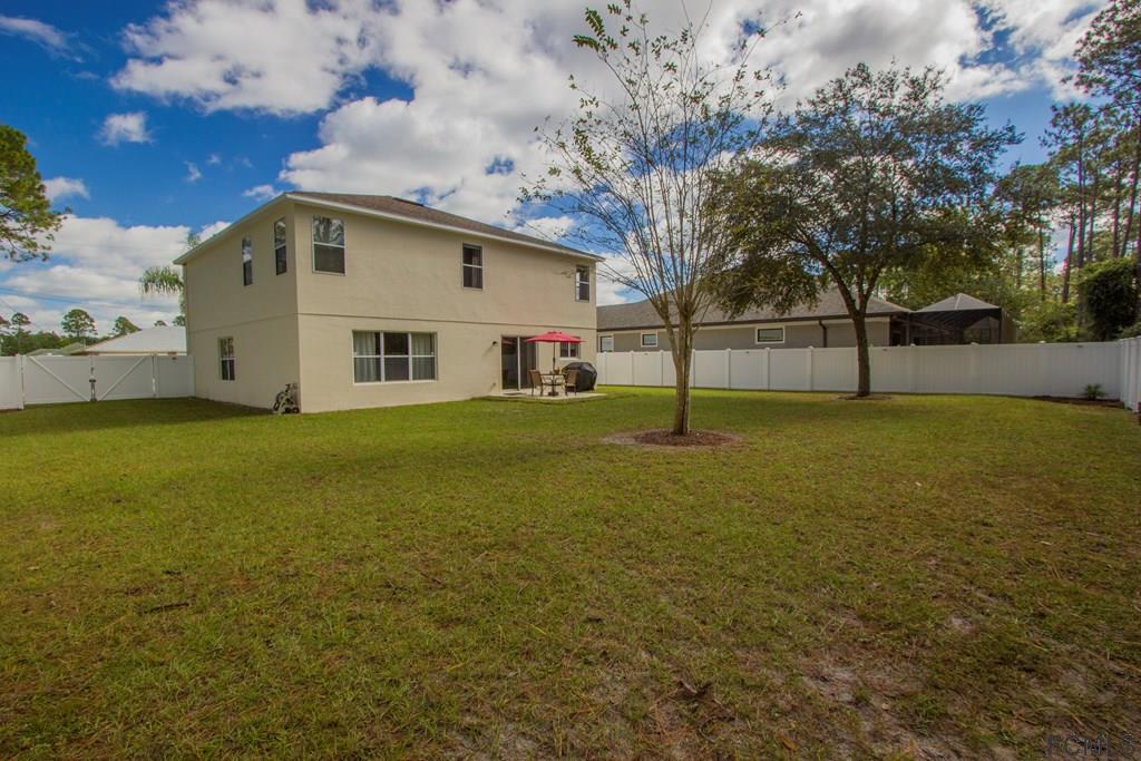 3 Riddle Place Palm Coast, FL 32164 - Photo 39 of 47 a view of a house with a yard
