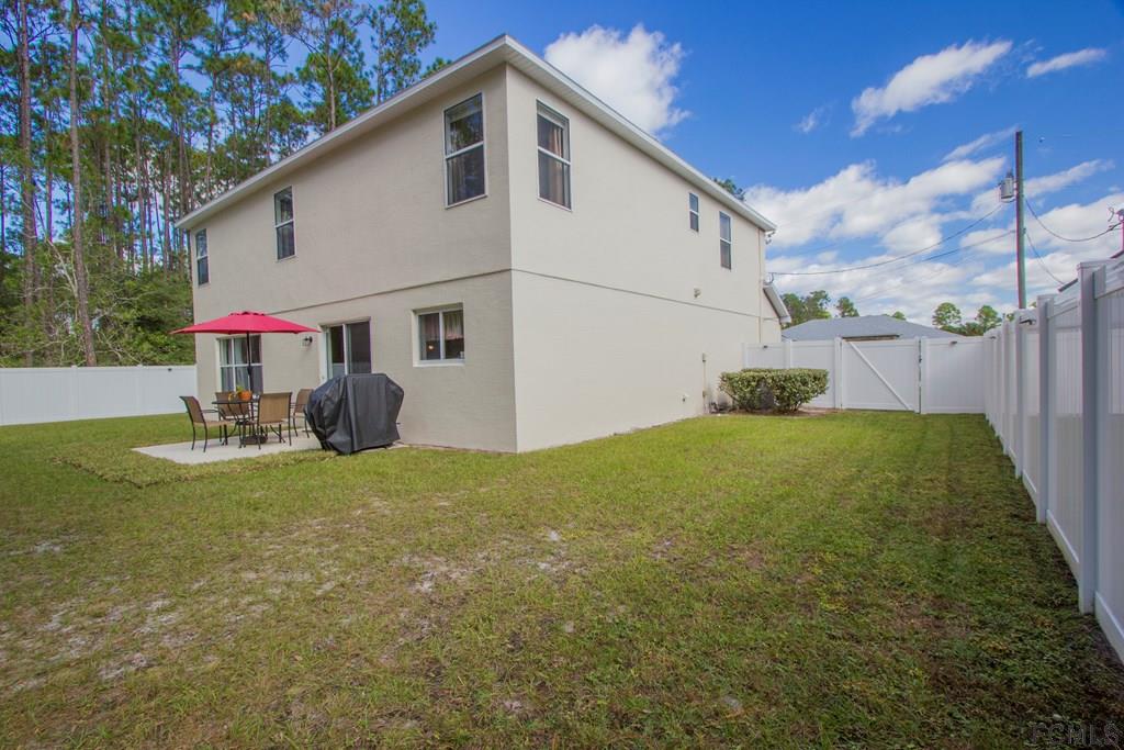3 Riddle Place Palm Coast, FL 32164 - Photo 42 of 47 a view of a back yard of the house