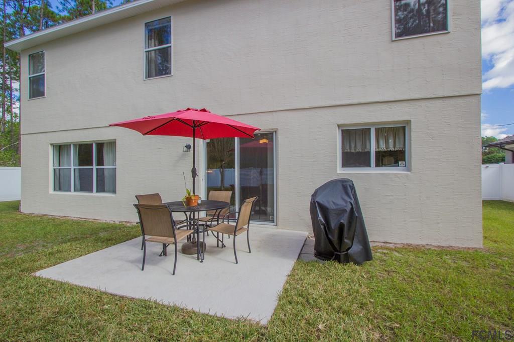 3 Riddle Place Palm Coast, FL 32164 - Photo 44 of 47 a view of a house with backyard sitting area and garden
