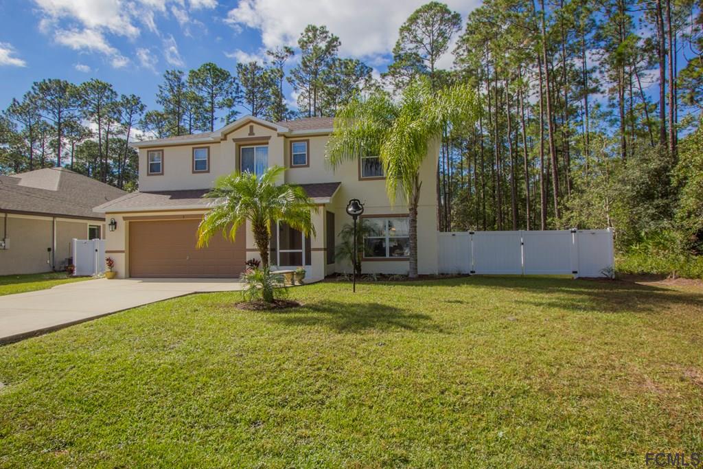 3 Riddle Place Palm Coast, FL 32164 - Photo 47 of 47 a view of a house with a backyard and a tree