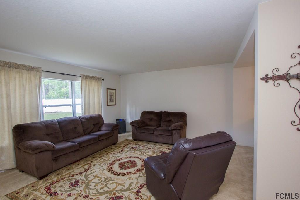 3 Riddle Place Palm Coast, FL 32164 - Photo 6 of 47 a living room with furniture and a window