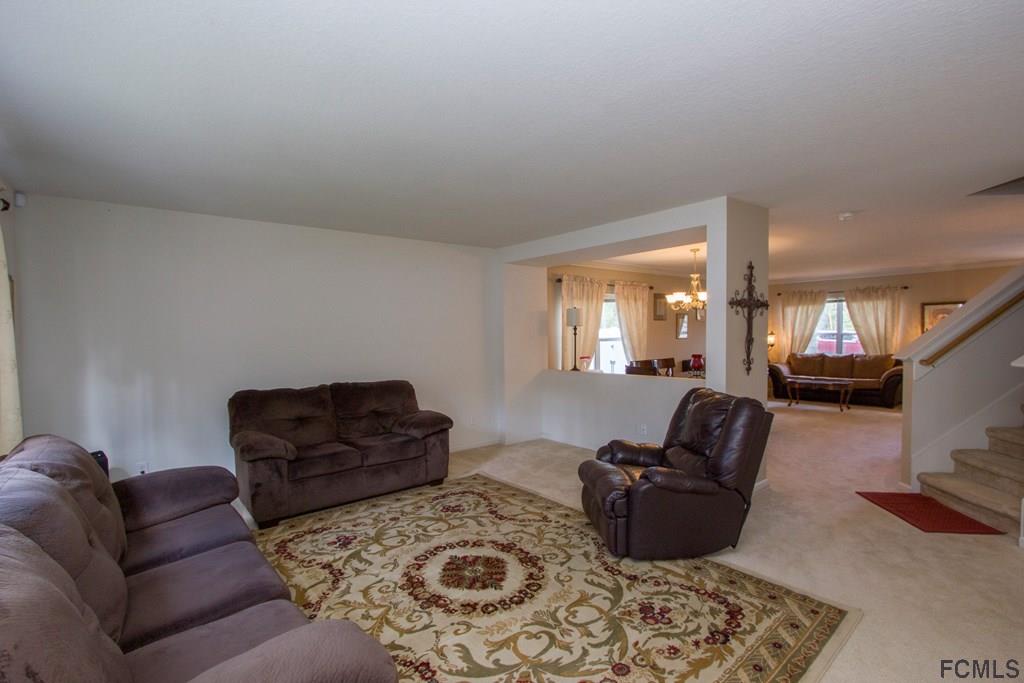 3 Riddle Place Palm Coast, FL 32164 - Photo 7 of 47 a living room with furniture window and a couch