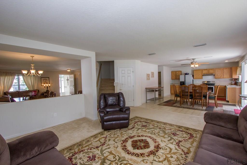 3 Riddle Place Palm Coast, FL 32164 - Photo 9 of 47 a living room with furniture and wooden floor
