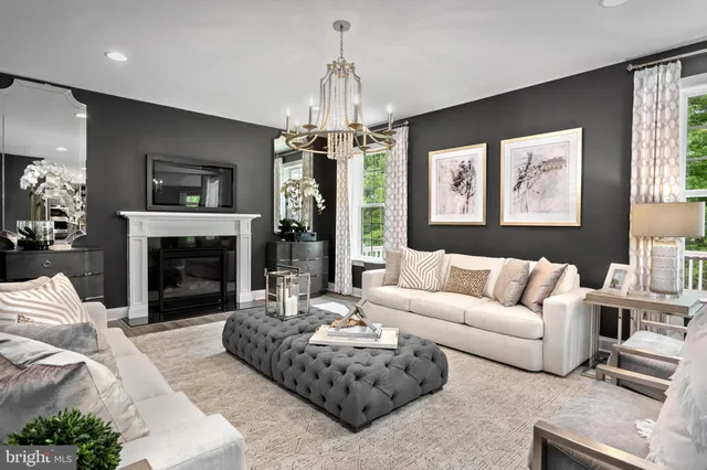 a living room with furniture a window and a fireplace