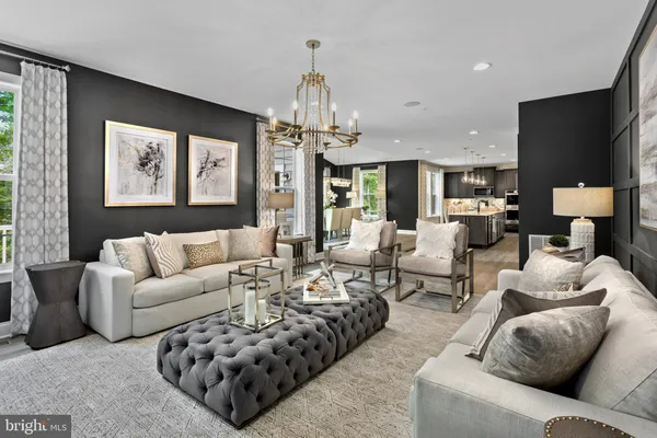 a living room with furniture ceiling fan and a chandelier