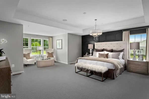 a spacious bedroom with a bed and a couch