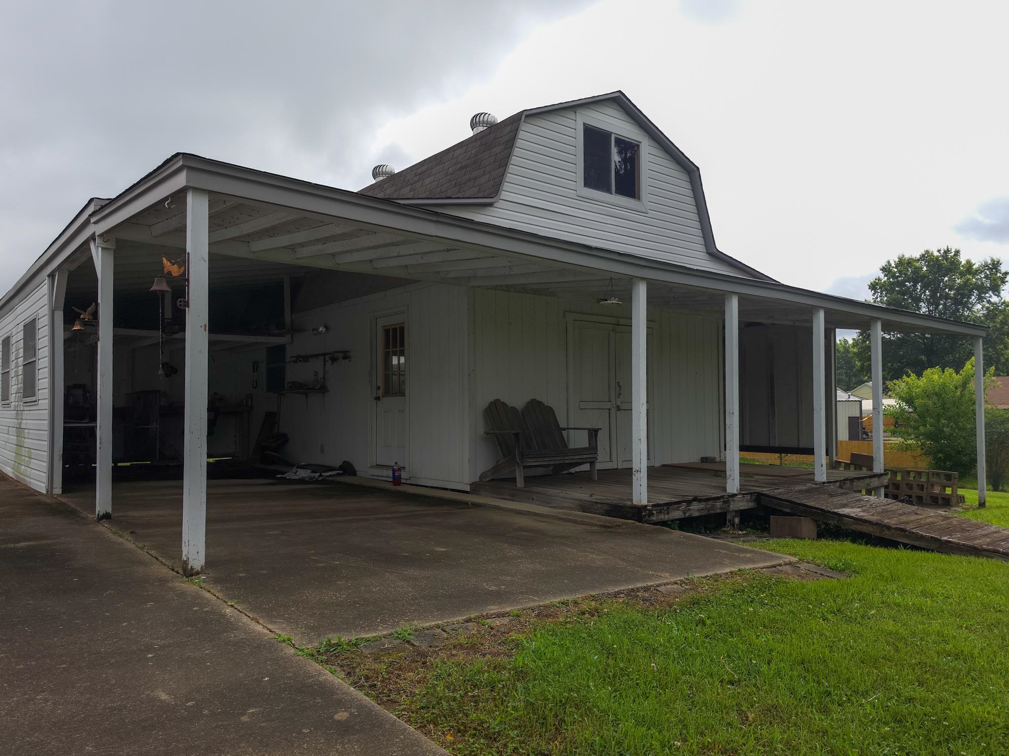 966 Beaver Road Munford, TN 38058 - Photo 31 of 32 Gambrel roof structure with white siding and an extended covered patio