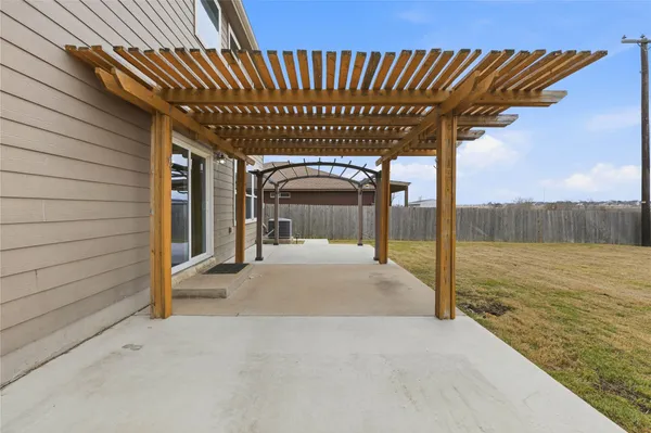 a view of a porch with a table and chairs