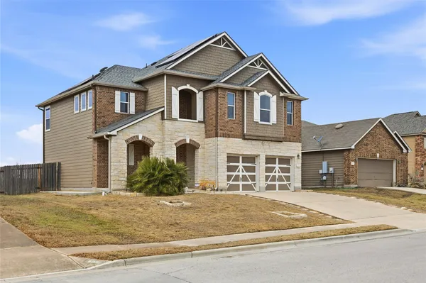 a front view of a house with a yard