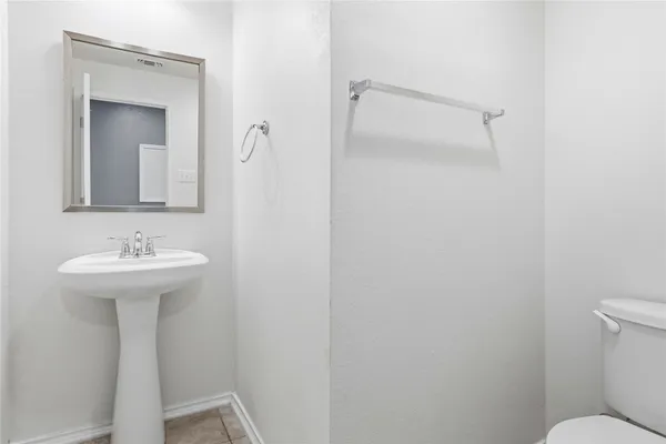 a bathroom with a sink toilet