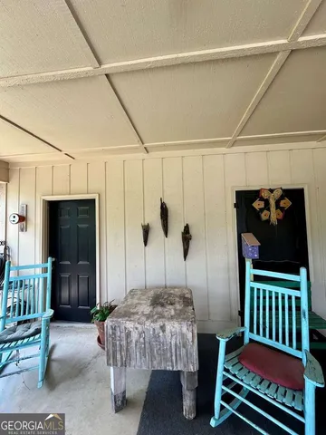 a bedroom with furniture and a flat screen tv