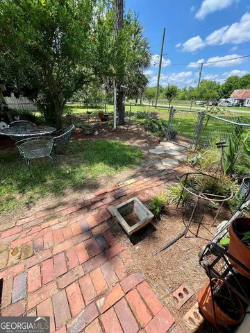a view of a backyard with table and chairs