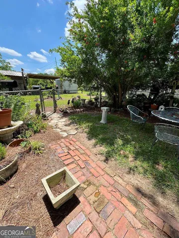 a view of a two chairs in a backyard
