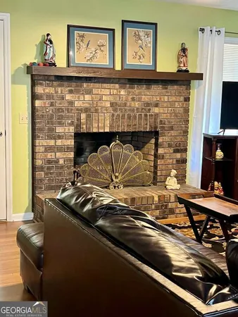 a view of a fireplace with two chairs
