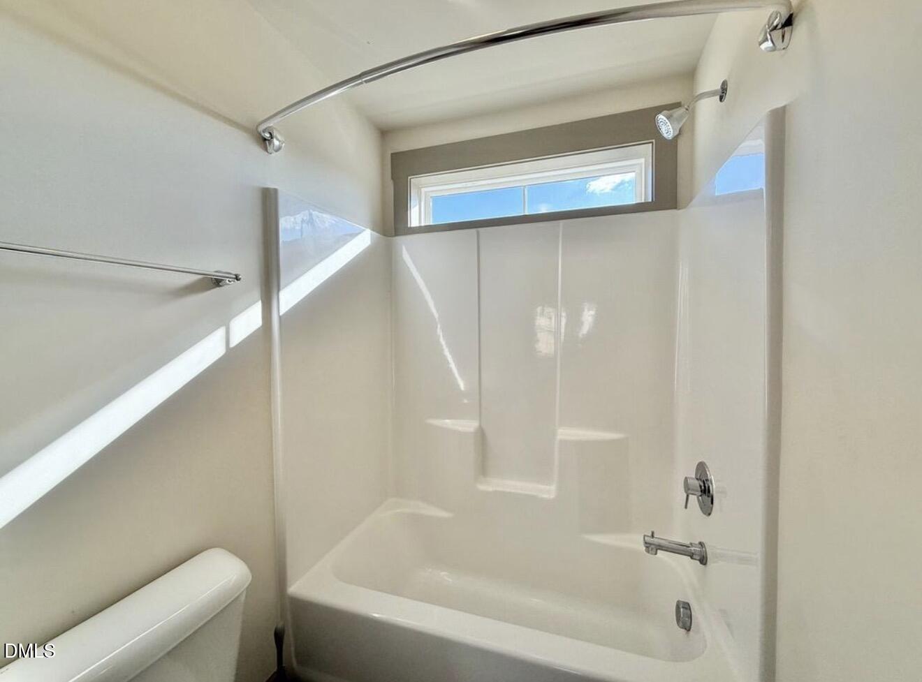 1529 Rhodeschool Drive Wendell, NC 27591 - Photo 21 of 36 a bathroom with a bathtub and a shower