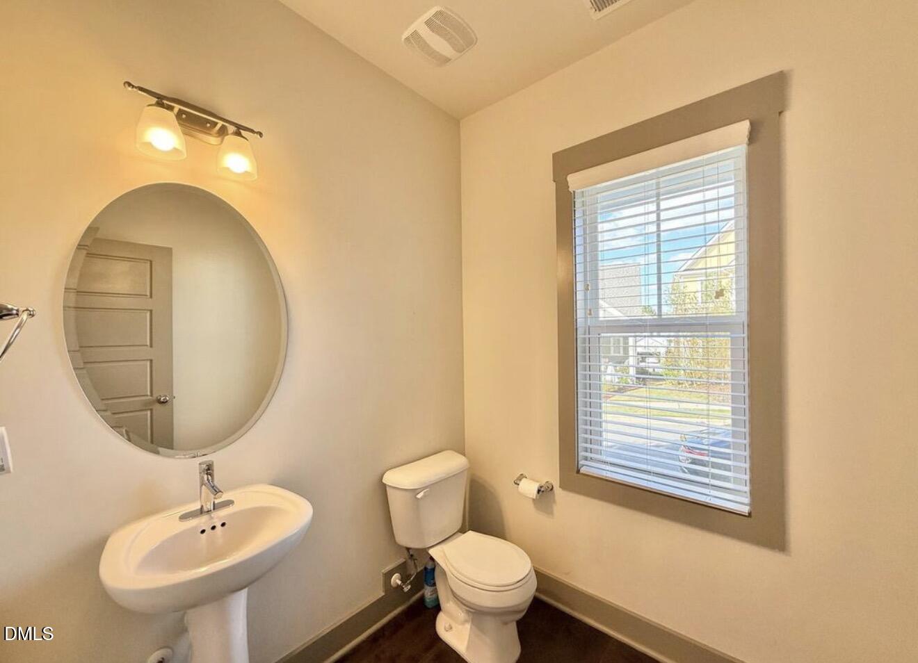 1529 Rhodeschool Drive Wendell, NC 27591 - Photo 8 of 36 a bathroom with a toilet a sink and mirror