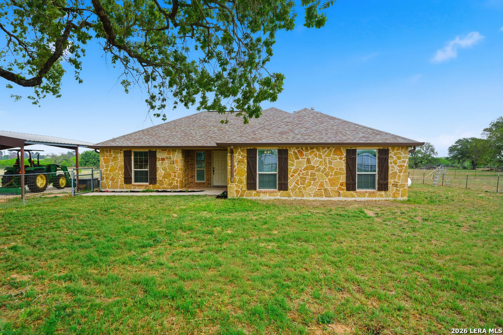 12897 La Vernia Road St. Hedwig, TX 78152 - Photo 31 of 34 a front view of a house with a garden