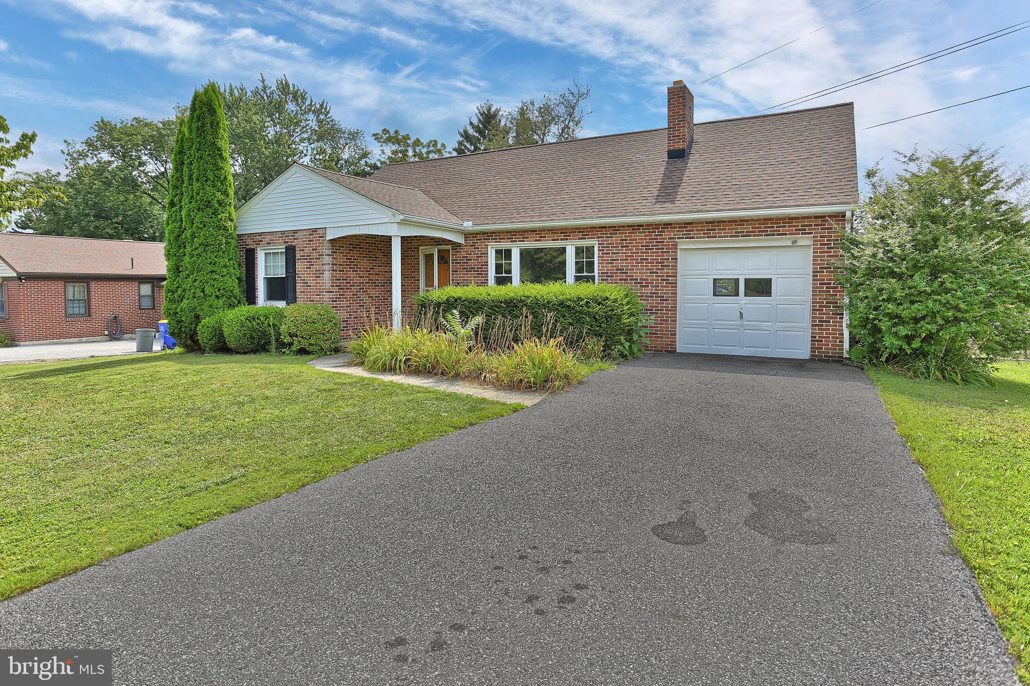 392 Waters Road York, PA 17403 - Photo 1 of 43 a front view of a house with a garden and yard