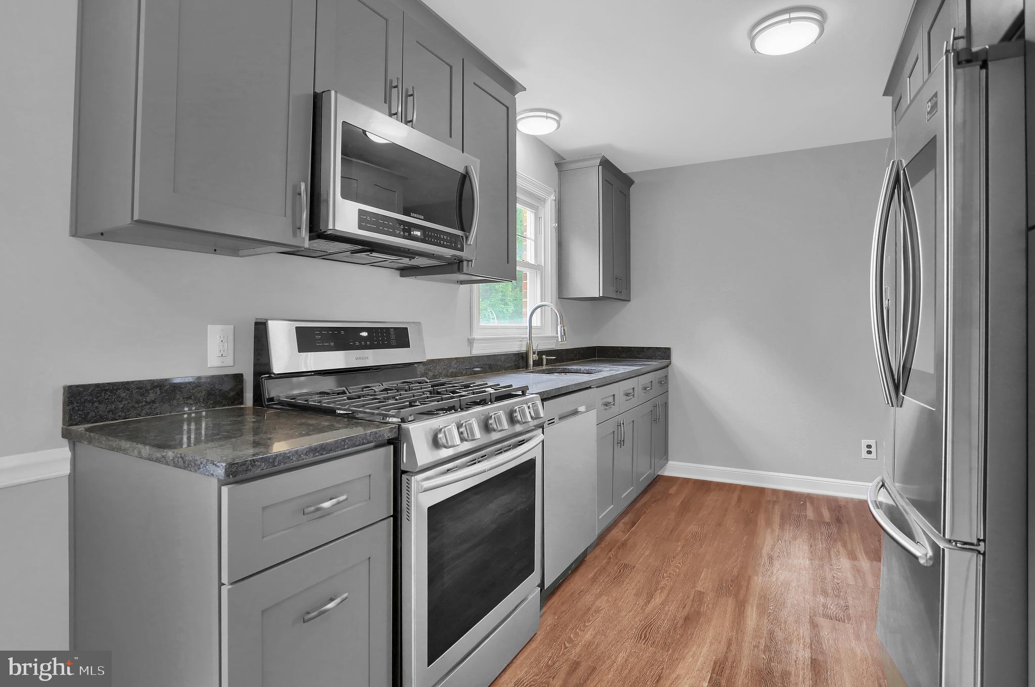 392 Waters Road York, PA 17403 - Photo 12 of 43 a kitchen with a sink stove and microwave