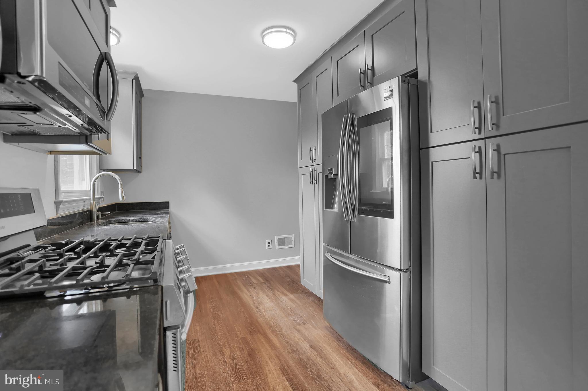 392 Waters Road York, PA 17403 - Photo 13 of 43 a kitchen with stainless steel appliances granite countertop a refrigerator and a stove top oven