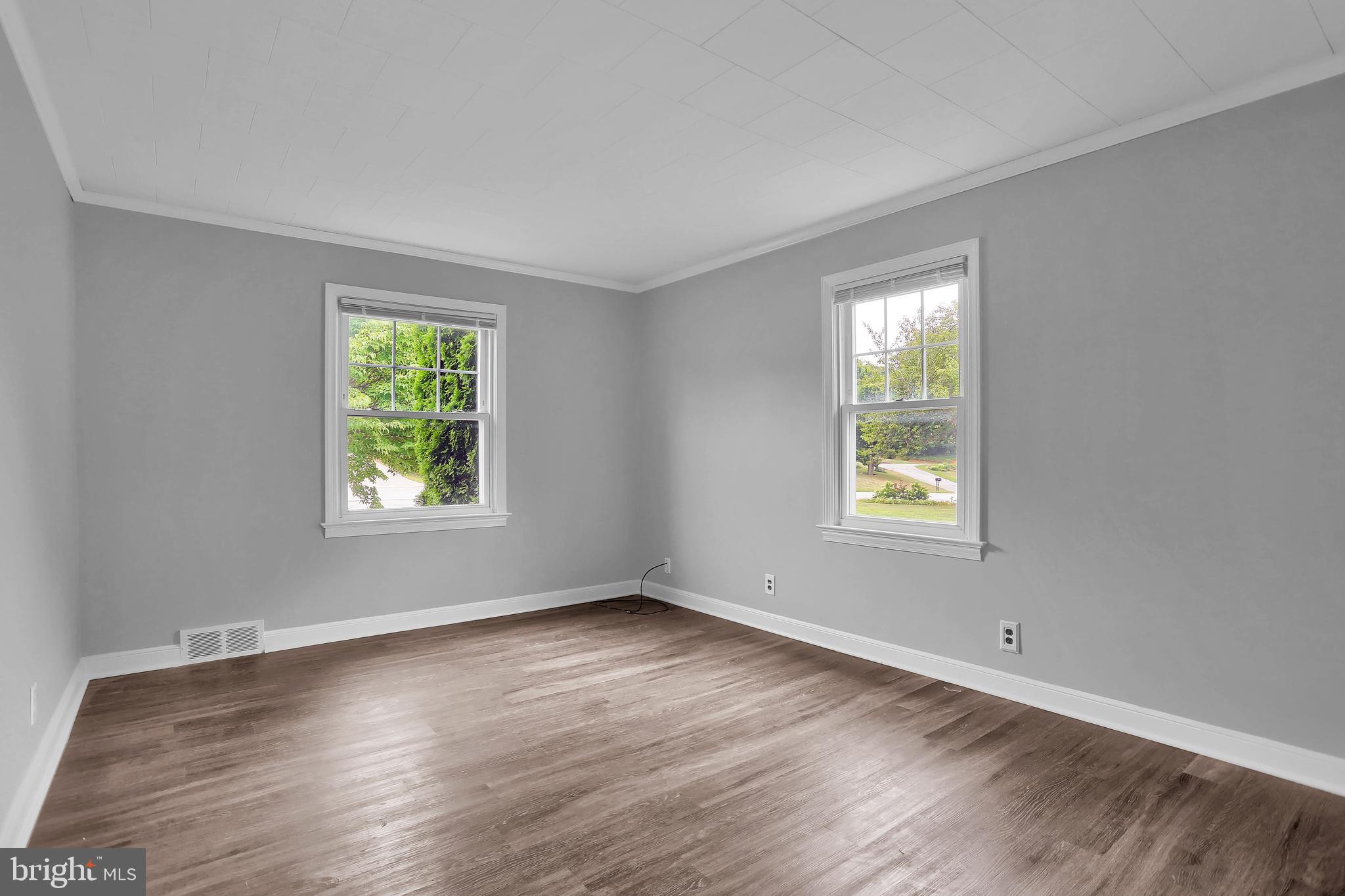 392 Waters Road York, PA 17403 - Photo 16 of 43 a view of an empty room with wooden floor and a window