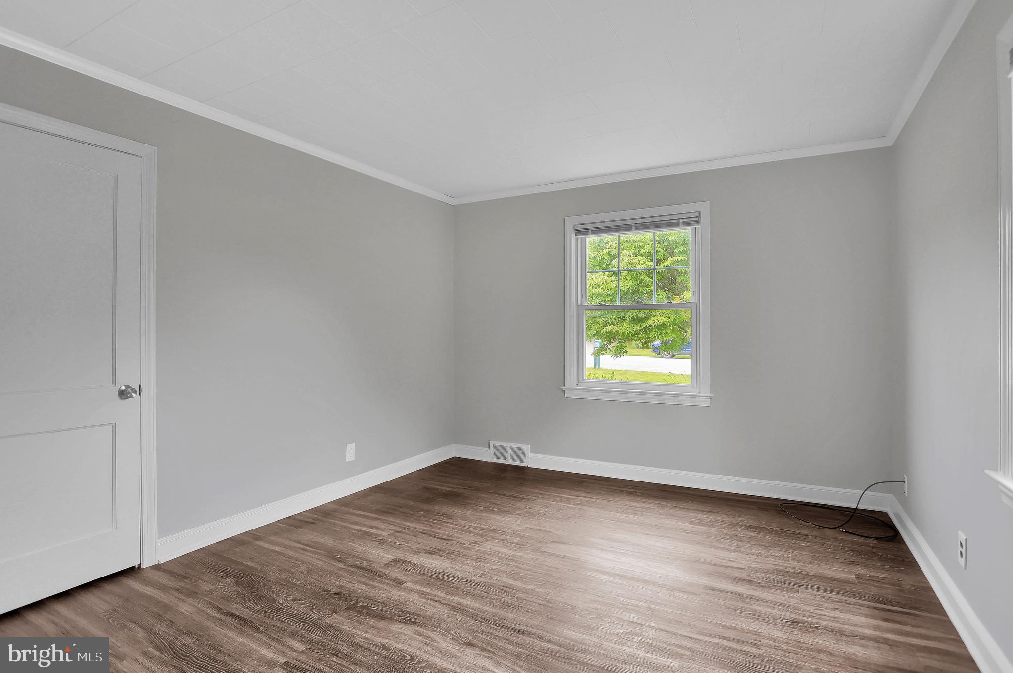 392 Waters Road York, PA 17403 - Photo 19 of 43 a view of an empty room with wooden floor and a window