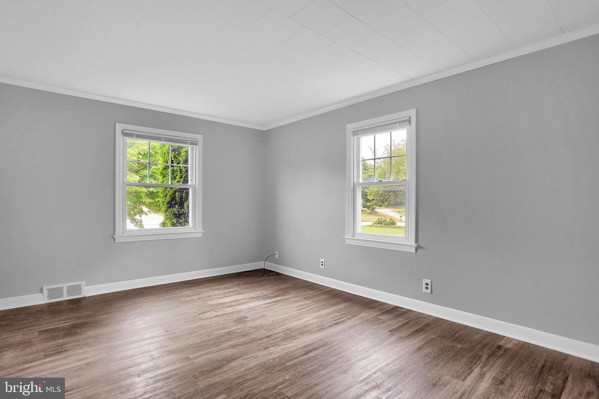 392 Waters Road York, PA 17403 - Photo 20 of 43 a view of an empty room with wooden floor and a window