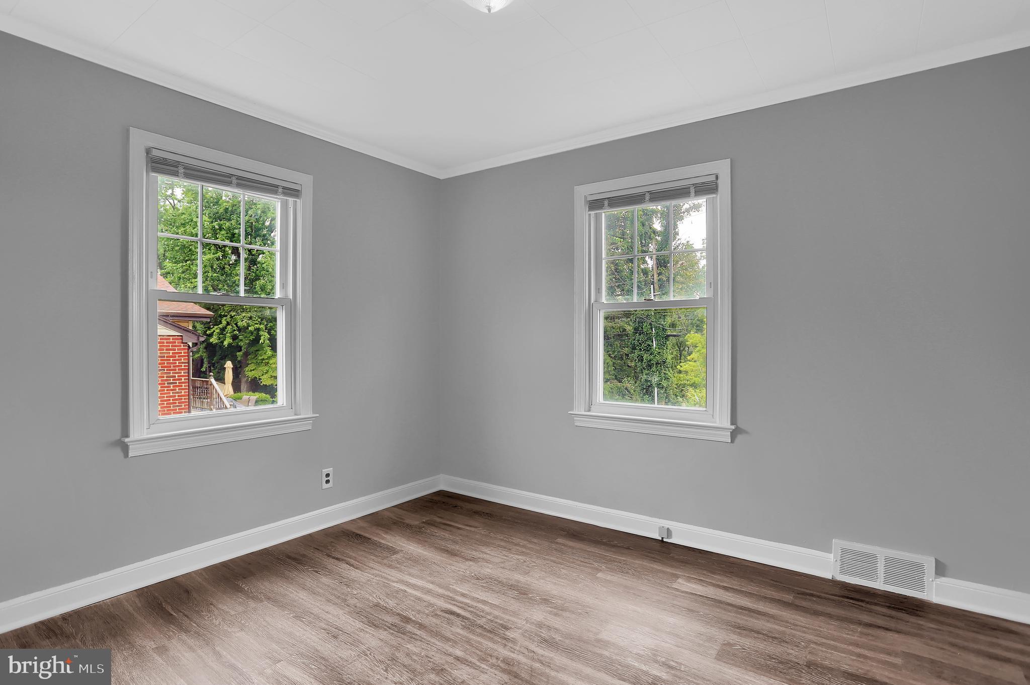 392 Waters Road York, PA 17403 - Photo 22 of 43 a view of an empty room with wooden floor and a window