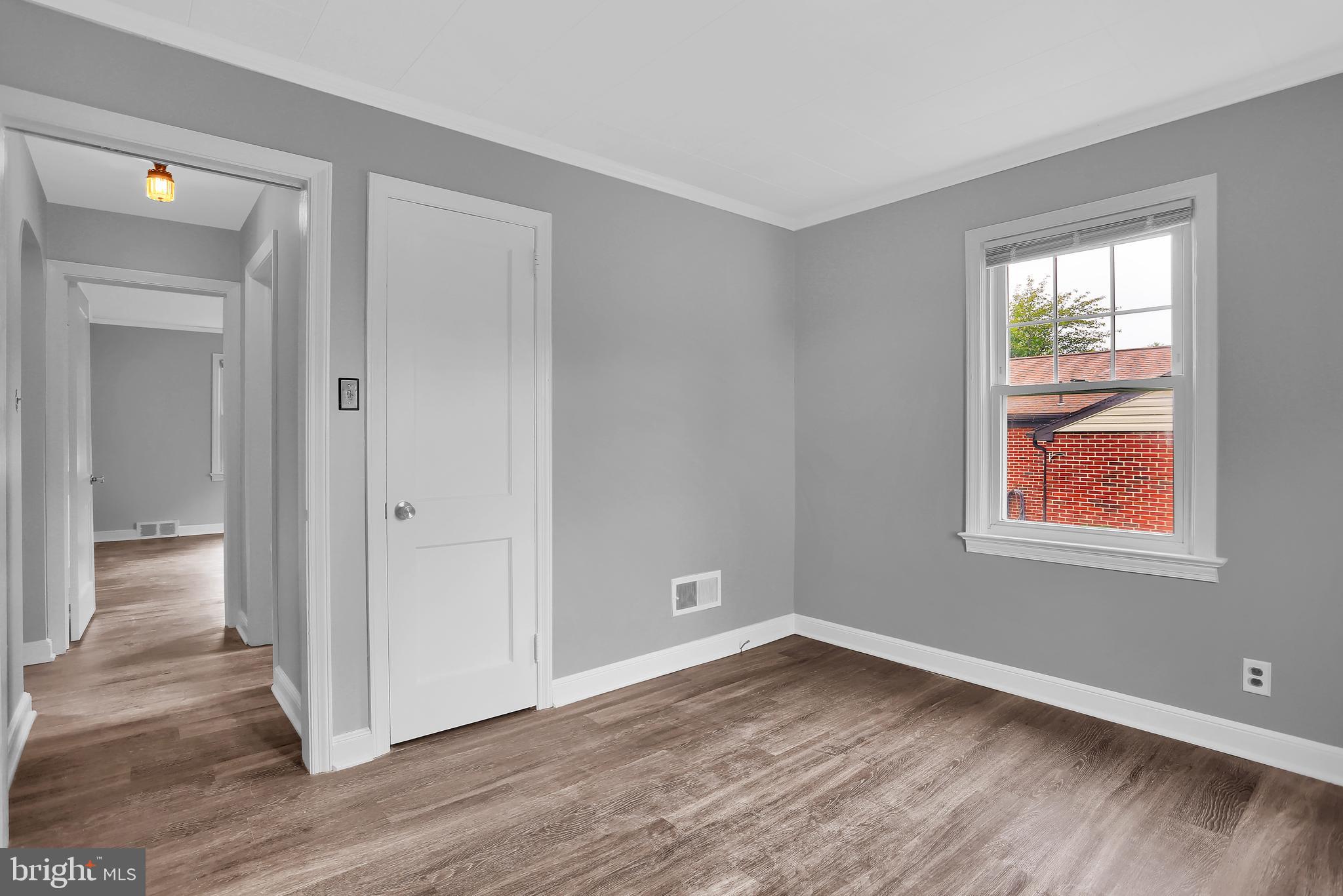 392 Waters Road York, PA 17403 - Photo 23 of 43 a view of an empty room with wooden floor and a window