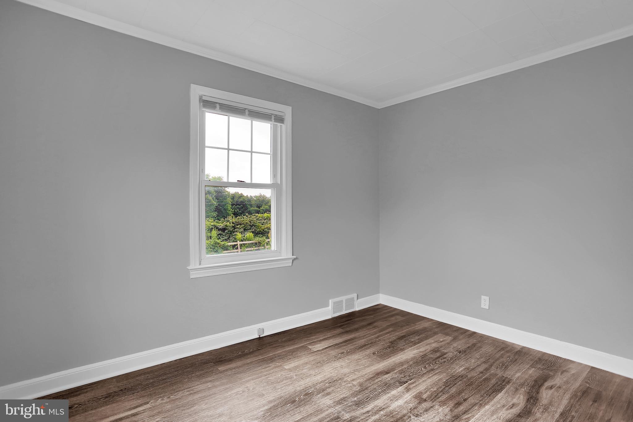 392 Waters Road York, PA 17403 - Photo 25 of 43 an empty room with wooden floor and windows