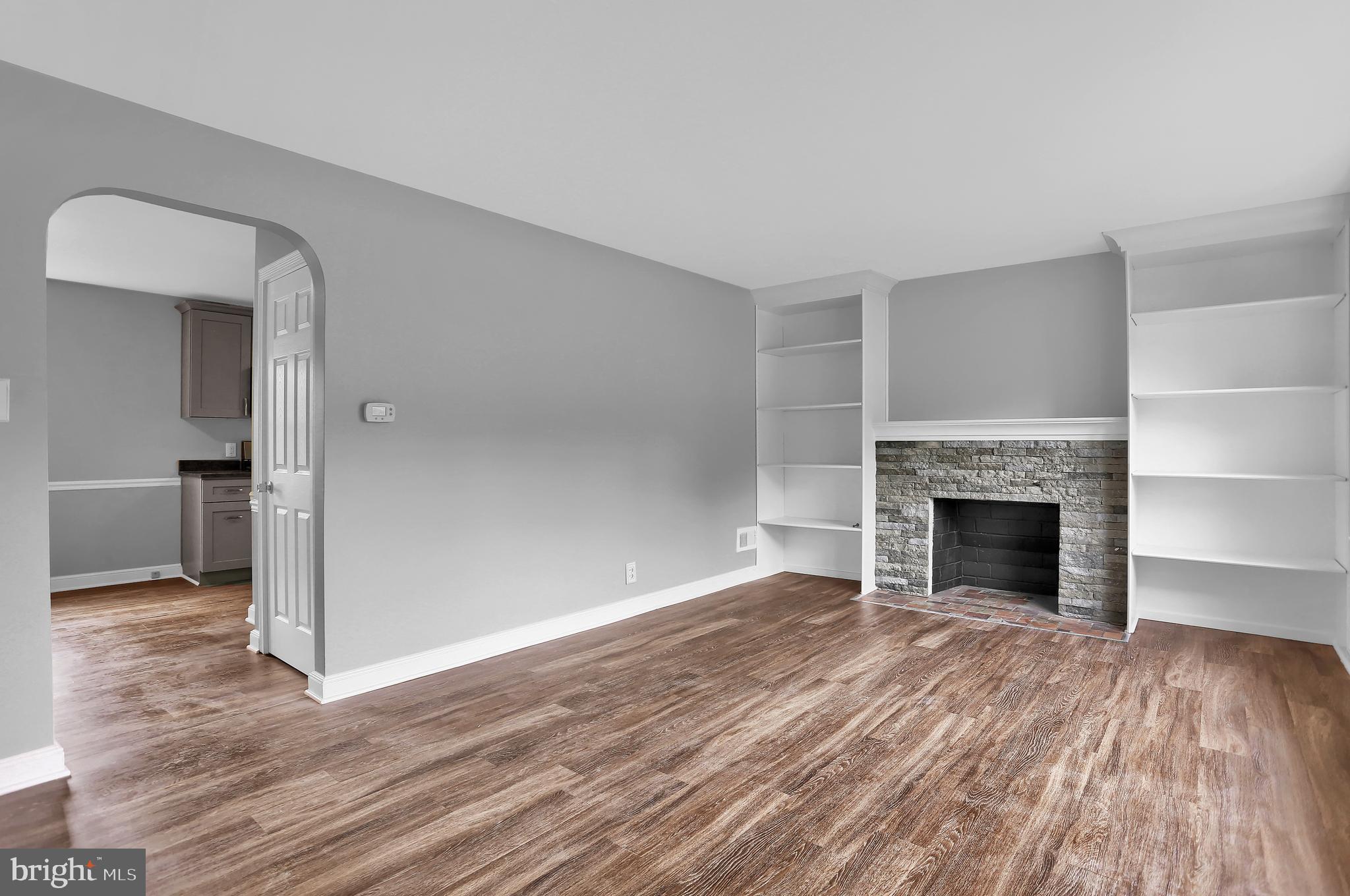 392 Waters Road York, PA 17403 - Photo 4 of 43 a view of a livingroom with wooden floor and a fireplace