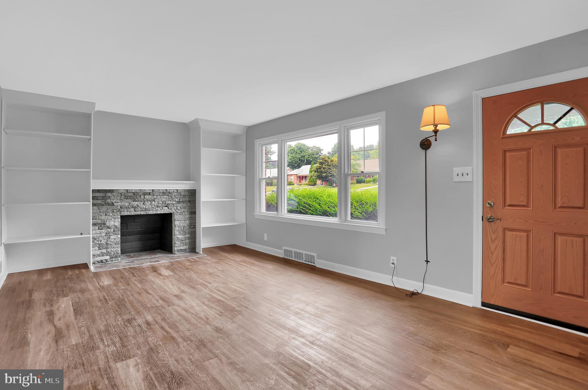 392 Waters Road York, PA 17403 - Photo 5 of 43 wooden floor fireplace and natural light in room