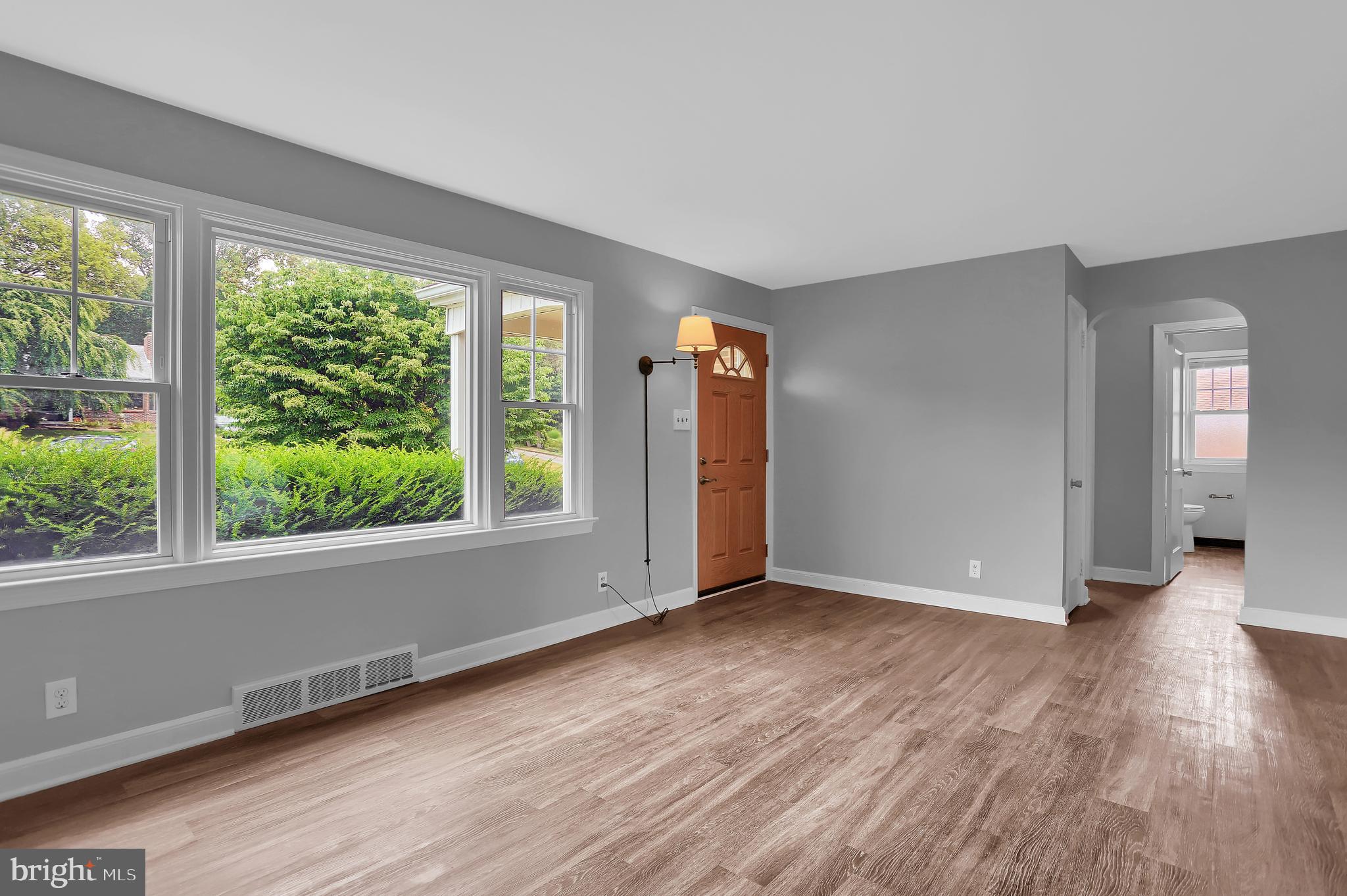 392 Waters Road York, PA 17403 - Photo 6 of 43 an empty room with wooden floor and windows