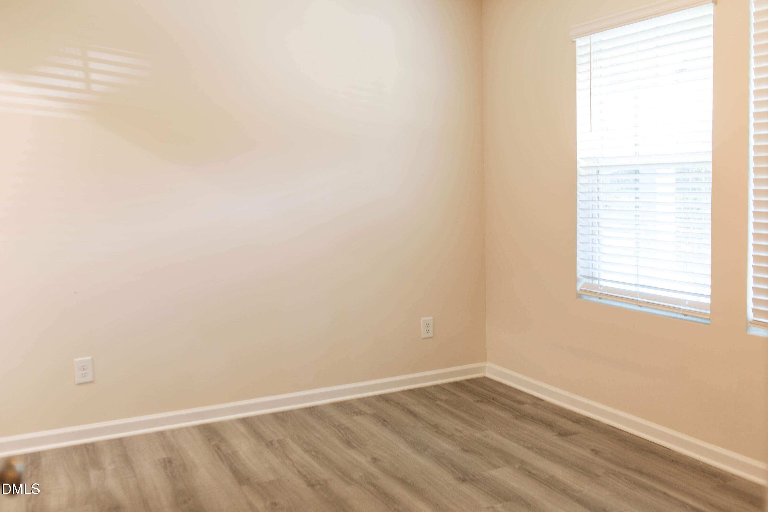 2801 Killian Court Raleigh, NC 27610 - Photo 4 of 26 a view of an empty room with wooden floor and a window