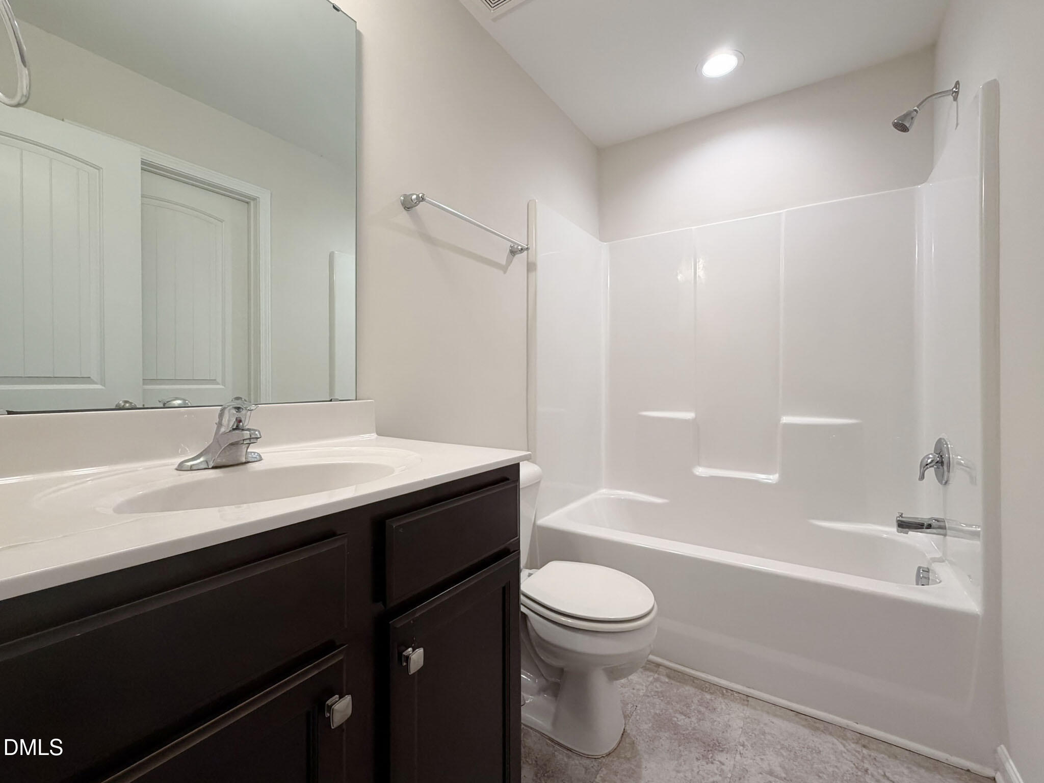 2801 Killian Court Raleigh, NC 27610 - Photo 5 of 26 a bathroom with a bathtub shower sink vanity mirror and toilet