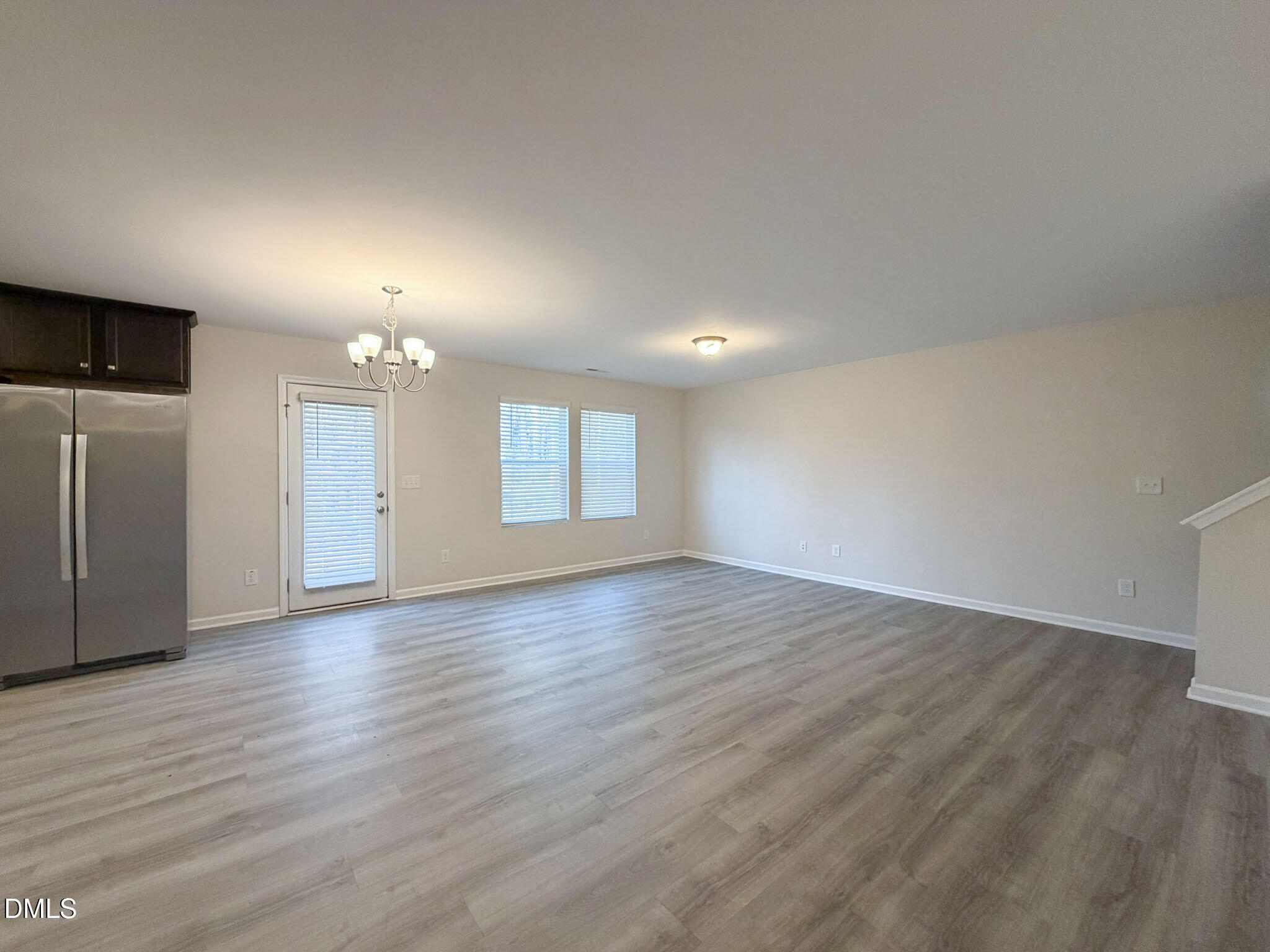 2801 Killian Court Raleigh, NC 27610 - Photo 9 of 26 an empty room with wooden floor and windows