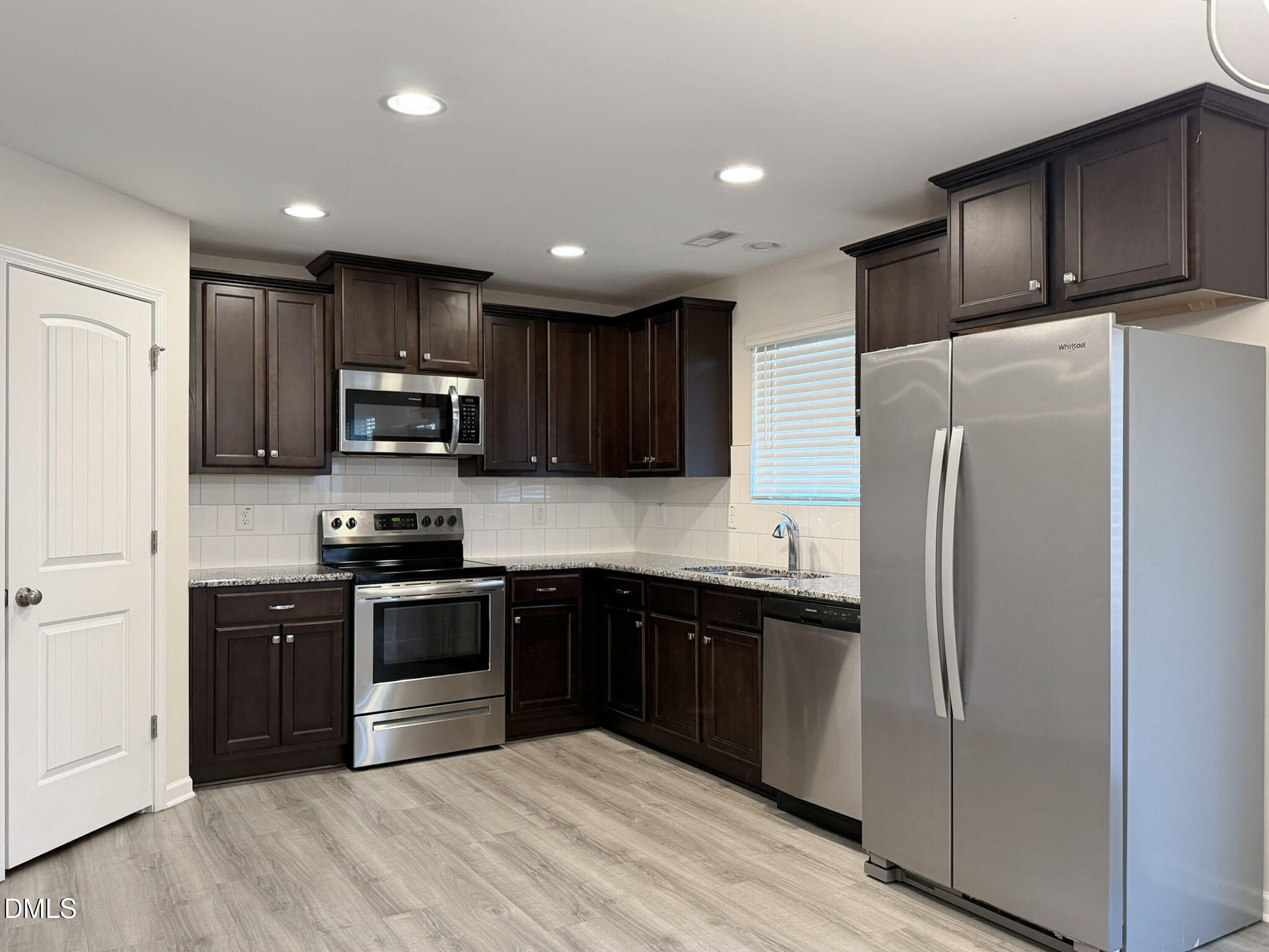 2801 Killian Court Raleigh, NC 27610 - Photo 10 of 26 a kitchen with stainless steel appliances granite countertop a refrigerator stove microwave and sink