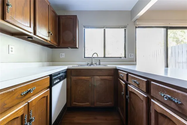 a kitchen with granite countertop a sink cabinets and window