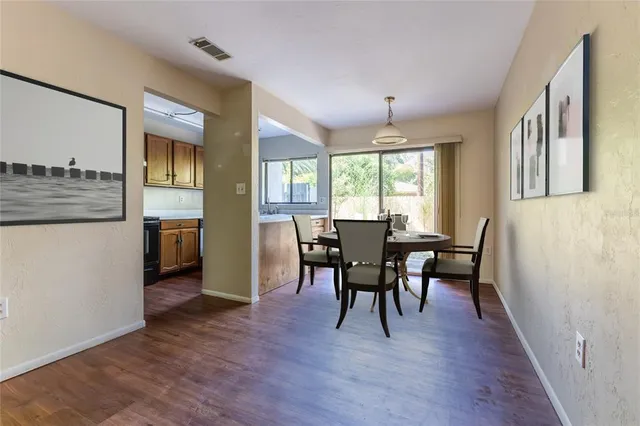 a view of a dining room with furniture window and wooden floor