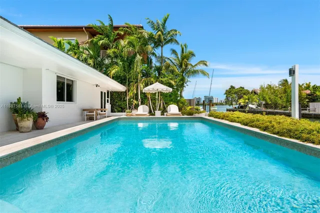 a view of swimming pool with outdoor seating and yard in back