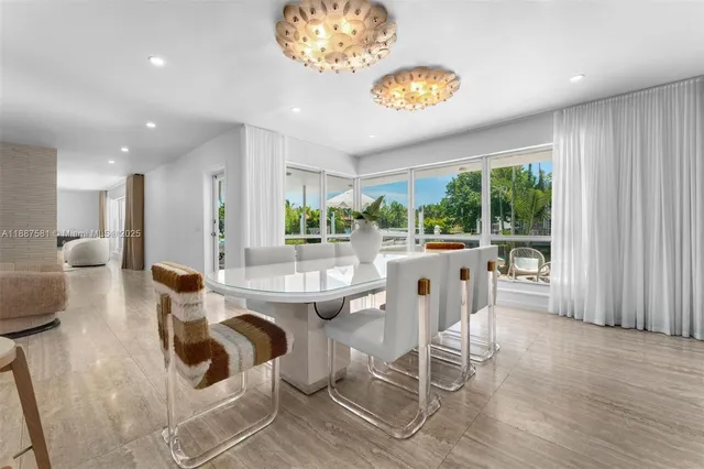 a dining room with wooden floor a chandelier a glass table and chairs