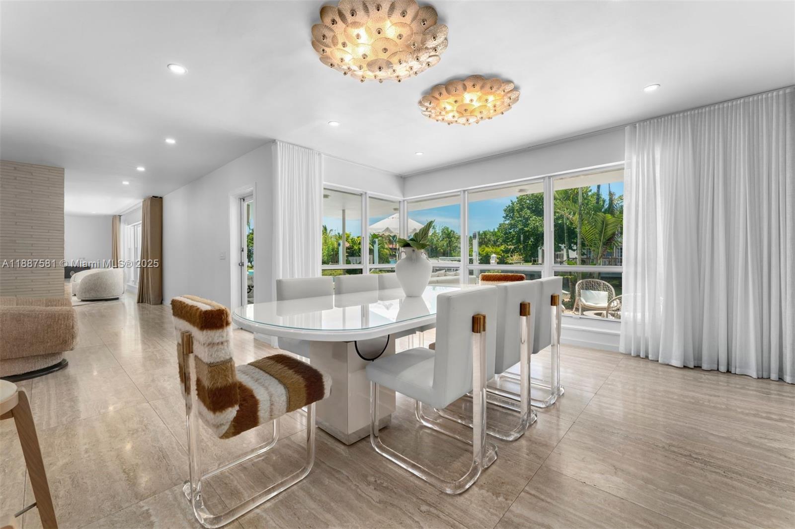 1250 Northeast 87th Street Miami, FL 33138 - Photo 13 of 53 a dining room with wooden floor a chandelier a glass table and chairs