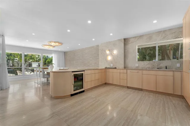 a large white kitchen with a large window