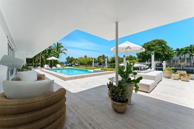 a view of backyard with outdoor seating and plants
