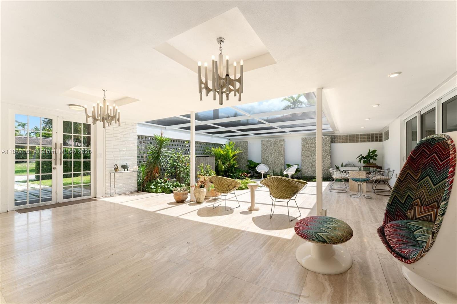 1250 Northeast 87th Street Miami, FL 33138 - Photo 4 of 53 a dining room with wooden floor and large windows