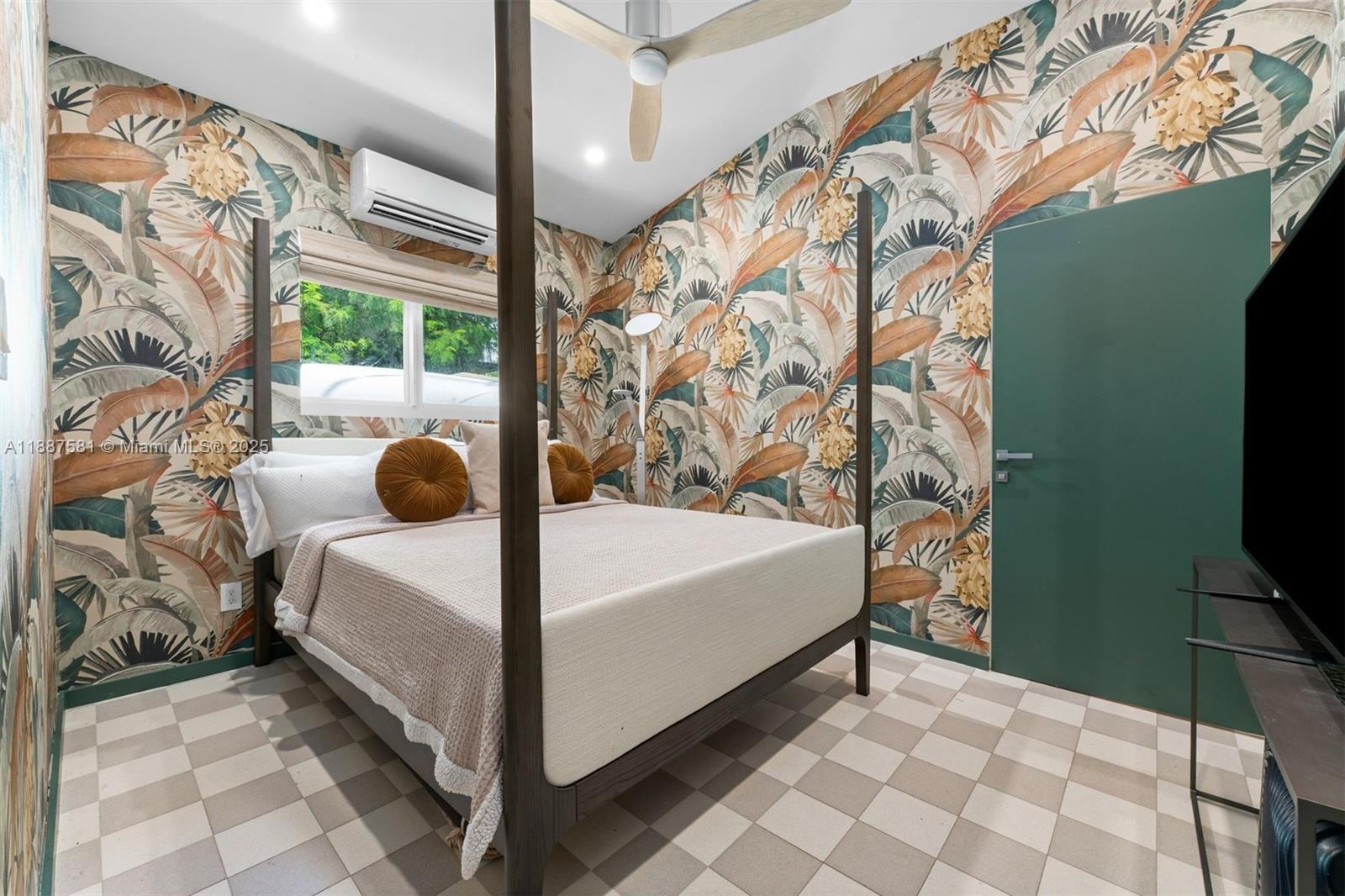 1250 Northeast 87th Street Miami, FL 33138 - Photo 43 of 53 a bedroom with a bed and a flat tv screen