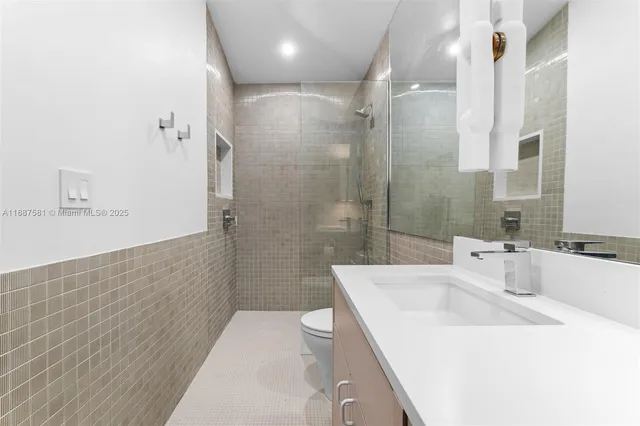 an aerial view of residential houses with outdoor space and lake view